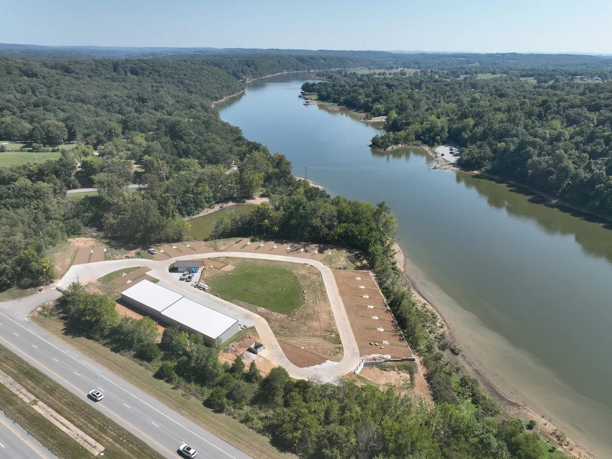 High aerial of the Belle Pointe peninsula, its loop road and the Beaver Lake cove