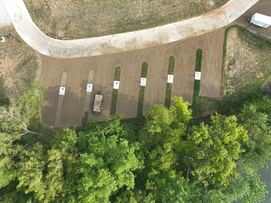 Top-down aerial of the fresh waterfront pads at Belle Pointe with the Beaver Lake shoreline below